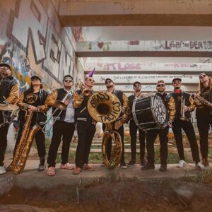 Brasstactics group photo with graffiti covered walls in the background