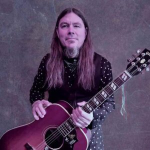 Dave McCann posing with his guitar