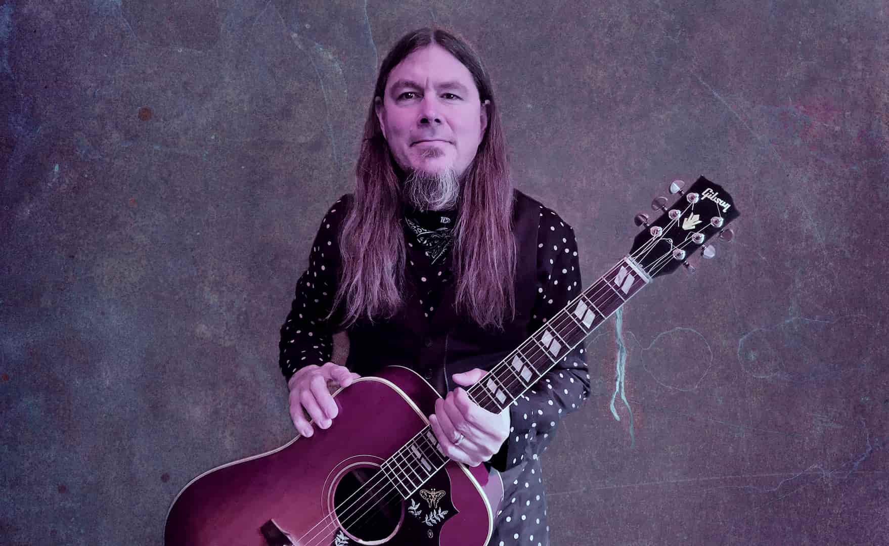 Dave McCann posing with his guitar