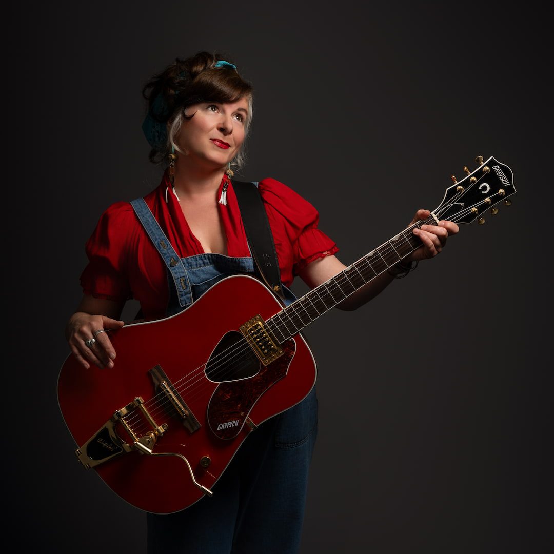 Little Miss Higgins posing with guitar