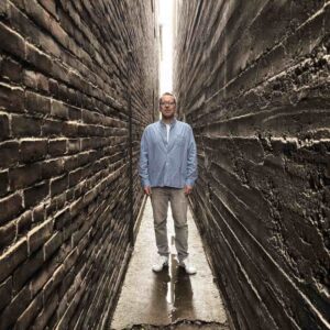 Mark Davis standing in a narrow alley