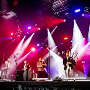 Skerryvore band photo on stage with bagpipes