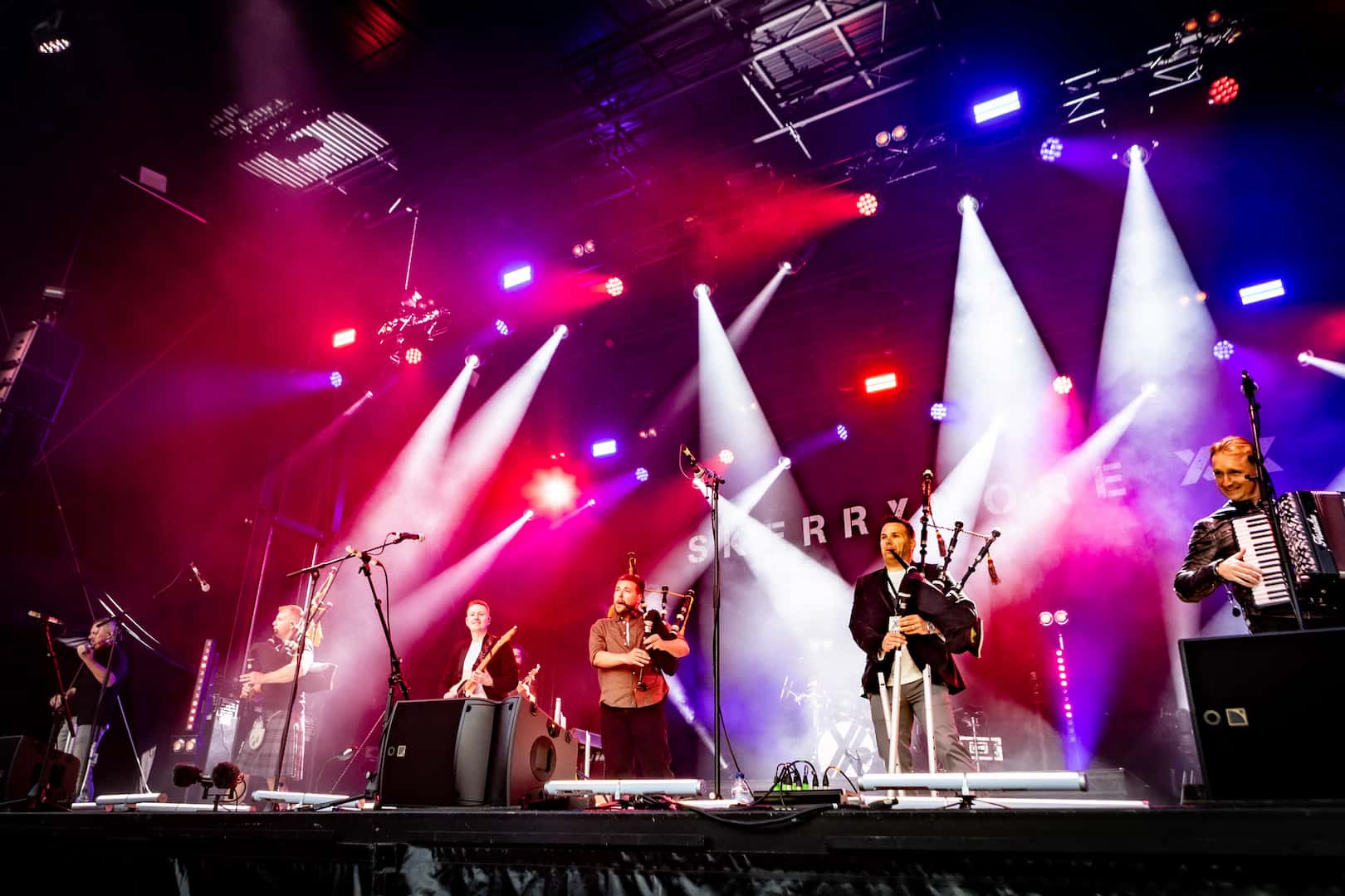Skerryvore band photo on stage with bagpipes