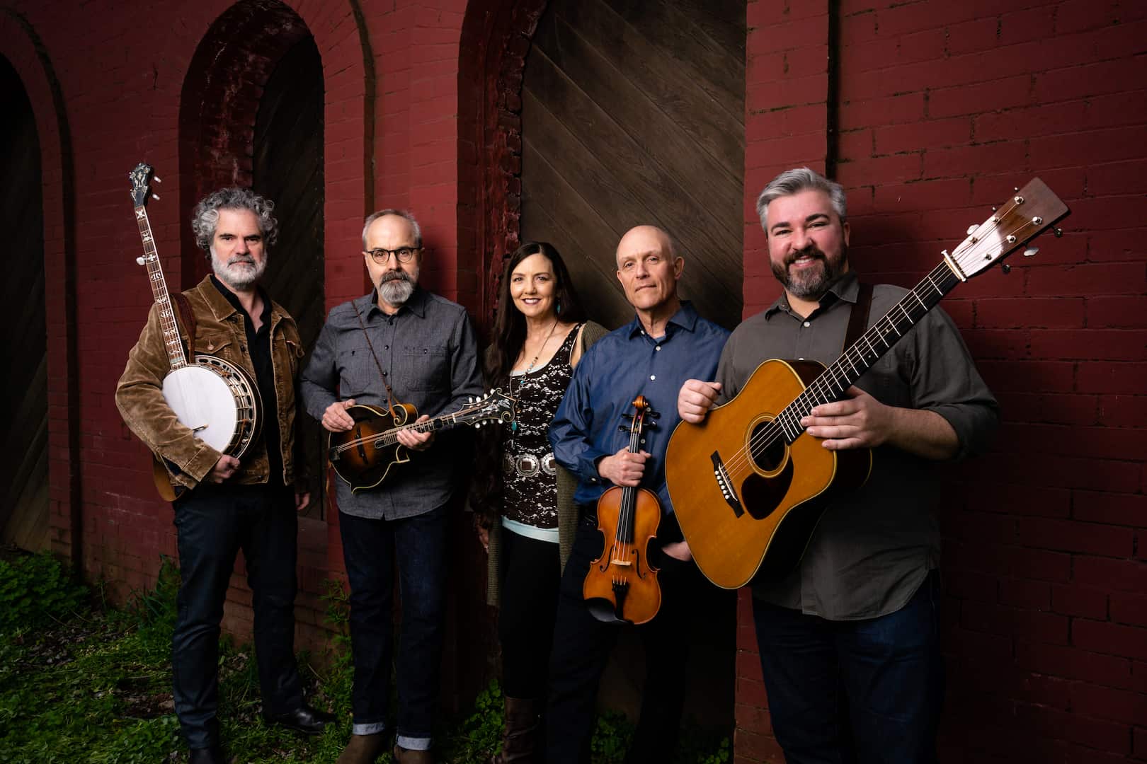 John Reischman and band posing with their instruments